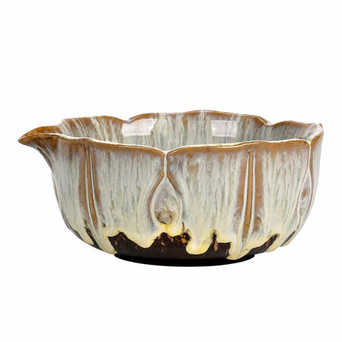 Kiln-glazed ceramic matcha bowl with a scalloped rim and a pouring spout, photographed on a white background