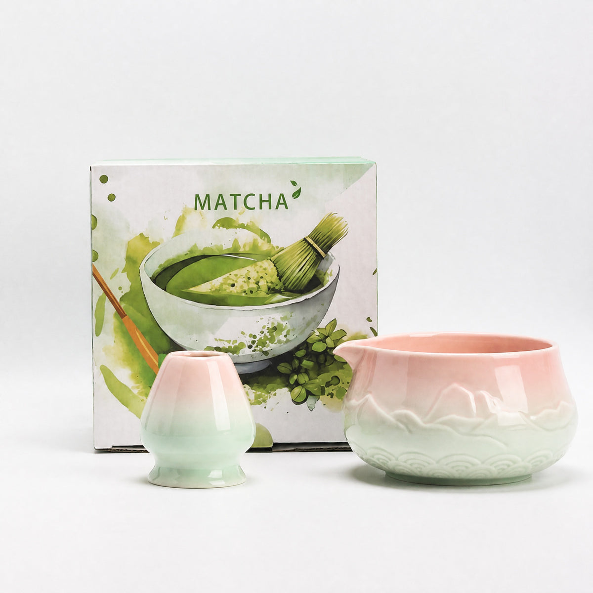 Pink and white gradient ceramic matcha bowl with bamboo whisk